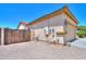 View of side yard with a wood fence, utility access, and gravel ground cover at 1761 N Hester Trl, Casa Grande, AZ 85122