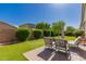 Inviting backyard with lush lawn, patio seating, and a beautiful landscape design at 17825 W Lincoln St, Goodyear, AZ 85338
