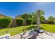 Lush backyard featuring a well-manicured lawn, mature trees, and an inviting patio area at 17825 W Lincoln St, Goodyear, AZ 85338