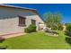 Exterior shot of home showing landscaped yard, covered patio, and comfortable outdoor seating at 17825 W Lincoln St, Goodyear, AZ 85338