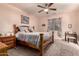 Comfortable bedroom with a ceiling fan, carpet flooring, and natural lighting at 17825 W Lincoln St, Goodyear, AZ 85338