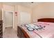 bedroom featuring Hello Kitty decor, closet, and view to the bathroom at 17825 W Lincoln St, Goodyear, AZ 85338