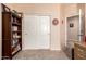 Bedroom with bookshelf, closet and entry door at 17825 W Lincoln St, Goodyear, AZ 85338