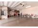 Spacious garage with epoxy floors, storage cabinets, work bench, and 3 bicycles at 17825 W Lincoln St, Goodyear, AZ 85338