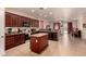 Well-equipped kitchen with an island, dark wood cabinetry, and modern appliances at 17825 W Lincoln St, Goodyear, AZ 85338