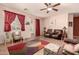 Bright living room with a ceiling fan, tiled floors, and sliding glass door access to back yard at 17825 W Lincoln St, Goodyear, AZ 85338