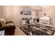 Cozy living room featuring neutral paint, tile floors, and lots of natural light at 17825 W Lincoln St, Goodyear, AZ 85338