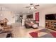 Inviting living room featuring tile flooring, ceiling fan, and seamless flow into the kitchen at 17825 W Lincoln St, Goodyear, AZ 85338