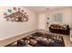 Inviting living room with decorative tree art, cozy furniture, and window views at 17825 W Lincoln St, Goodyear, AZ 85338