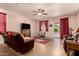 Comfortable living room featuring a ceiling fan, plush furniture, and access to the backyard at 17825 W Lincoln St, Goodyear, AZ 85338