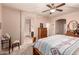 Spacious main bedroom featuring carpet floors, a ceiling fan, and access to an ensuite bathroom at 17825 W Lincoln St, Goodyear, AZ 85338