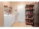 Pantry with a white washer and dryer, door, and plentiful shelving at 17825 W Lincoln St, Goodyear, AZ 85338