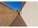 Functional side yard with gravel and block wall, offering privacy and utility at 17825 W Lincoln St, Goodyear, AZ 85338