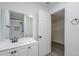 Bathroom featuring a vanity with white cabinets, a dark faucet, a large mirror, and a walk-in shower at 1847 E Kirkland Ln # C, Tempe, AZ 85281