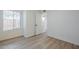 Bright bedroom featuring wood-look floors, white walls, and a window with natural light at 1847 E Kirkland Ln # C, Tempe, AZ 85281