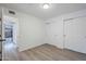 Neutral bedroom with wood-look floors, white walls, and double sliding-door closet at 1847 E Kirkland Ln # C, Tempe, AZ 85281
