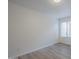 Bedroom featuring wood-look flooring, neutral paint, and a large window at 1847 E Kirkland Ln # C, Tempe, AZ 85281
