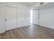 Bedroom featuring wood-look flooring, neutral paint, and large closet with sliding doors at 1847 E Kirkland Ln # C, Tempe, AZ 85281