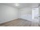 Bedroom featuring wood-look flooring, neutral paint, and large closet with sliding doors at 1847 E Kirkland Ln # C, Tempe, AZ 85281