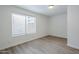 Bedroom featuring wood-look flooring, neutral paint, and a large window at 1847 E Kirkland Ln # C, Tempe, AZ 85281