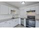 Kitchen featuring white cabinets, granite countertops, stainless steel appliances, and wood-look flooring at 1847 E Kirkland Ln # C, Tempe, AZ 85281