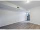 Bright living room featuring wood-look flooring, neutral paint, and sliding glass doors to the outdoor space at 1847 E Kirkland Ln # C, Tempe, AZ 85281