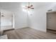 Open living room with vaulted ceilings, ceiling fan, and wood look floors at 1847 E Kirkland Ln # C, Tempe, AZ 85281