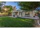 Lush backyard with a covered patio featuring a grill and seating, perfect for outdoor gatherings and relaxation at 2045 E San Carlos Pl, Chandler, AZ 85249
