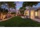 Beautiful backyard featuring a lush green lawn, trees, and a covered patio, perfect for outdoor relaxation and entertaining at 2045 E San Carlos Pl, Chandler, AZ 85249