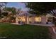Expansive backyard featuring a covered patio, built-in grill, lush lawn, and mature trees, ideal for outdoor living at 2045 E San Carlos Pl, Chandler, AZ 85249