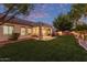 Grassy backyard featuring a covered patio with outdoor seating and a built-in grill, ideal for entertaining guests at 2045 E San Carlos Pl, Chandler, AZ 85249