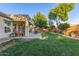 Lush backyard featuring a covered patio, outdoor seating, built-in grill, and beautiful landscaping, creating a relaxing outdoor oasis at 2045 E San Carlos Pl, Chandler, AZ 85249