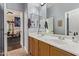 Bathroom with double vanity sinks, oak cabinets, large mirrors, and tile flooring at 2045 E San Carlos Pl, Chandler, AZ 85249
