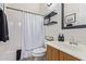 Bathroom with a shower, tub, single vanity sink, decorative shelving, and modern fixtures at 2045 E San Carlos Pl, Chandler, AZ 85249