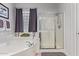 Bright bathroom features a soaking tub, glass block window, and glass-enclosed shower at 2045 E San Carlos Pl, Chandler, AZ 85249