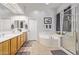 Bright bathroom with double sink vanity, soaking tub, and separate glass shower at 2045 E San Carlos Pl, Chandler, AZ 85249