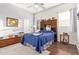 Comfortable bedroom with wood flooring, rustic furnishings, and natural light from bright sunny windows at 2045 E San Carlos Pl, Chandler, AZ 85249
