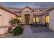 Inviting home featuring a cozy front patio with outdoor seating and a charming fountain, all illuminated at twilight at 2045 E San Carlos Pl, Chandler, AZ 85249