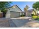 Attractive home offering a three-car garage, inviting front patio, and neatly landscaped yard on a bright day at 2045 E San Carlos Pl, Chandler, AZ 85249