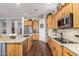 Kitchen featuring stainless steel appliances, wooden cabinets, and granite countertops at 2045 E San Carlos Pl, Chandler, AZ 85249