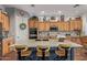 Open kitchen with large island, granite countertops, wood cabinets, and stainless appliances at 2045 E San Carlos Pl, Chandler, AZ 85249