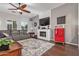 Cozy living room with stylish fireplace, ceiling fan, and classic Coca-Cola cooler at 2045 E San Carlos Pl, Chandler, AZ 85249