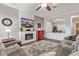 Comfortable living room showcasing a fireplace, vintage Coca-Cola cooler, and a view to the dining area at 2045 E San Carlos Pl, Chandler, AZ 85249