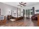 Primary bedroom featuring a dark wood bed frame, hardwood flooring, and natural light at 2045 E San Carlos Pl, Chandler, AZ 85249