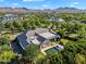 Beautiful home featuring a sparkling pool and lush green landscaping with mountain views at 20644 E Sunrise Ct, Queen Creek, AZ 85142