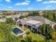 Beautiful home featuring a sparkling pool and lush green landscaping with a large patio at 20644 E Sunrise Ct, Queen Creek, AZ 85142