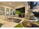 Backyard features a stone water fountain, a ping pong table, and an expansive patio area for outdoor entertainment at 20644 E Sunrise Ct, Queen Creek, AZ 85142