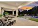 Expansive outdoor living space with a covered patio, fireplace, pool, and lush landscaping, perfect for entertaining at 20644 E Sunrise Ct, Queen Creek, AZ 85142
