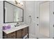 Stylish bathroom featuring a dark wood vanity, modern fixtures, and a frosted glass door at 20644 E Sunrise Ct, Queen Creek, AZ 85142