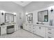Bright bathroom featuring white cabinetry, dual sinks, and large mirrors at 20644 E Sunrise Ct, Queen Creek, AZ 85142